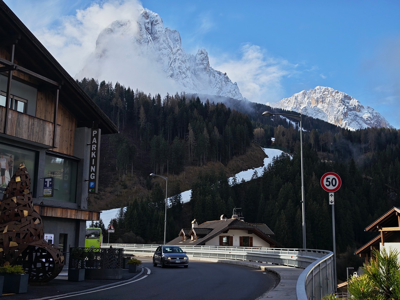 Ortisei village rooftops and church with Dolomites backdrop
