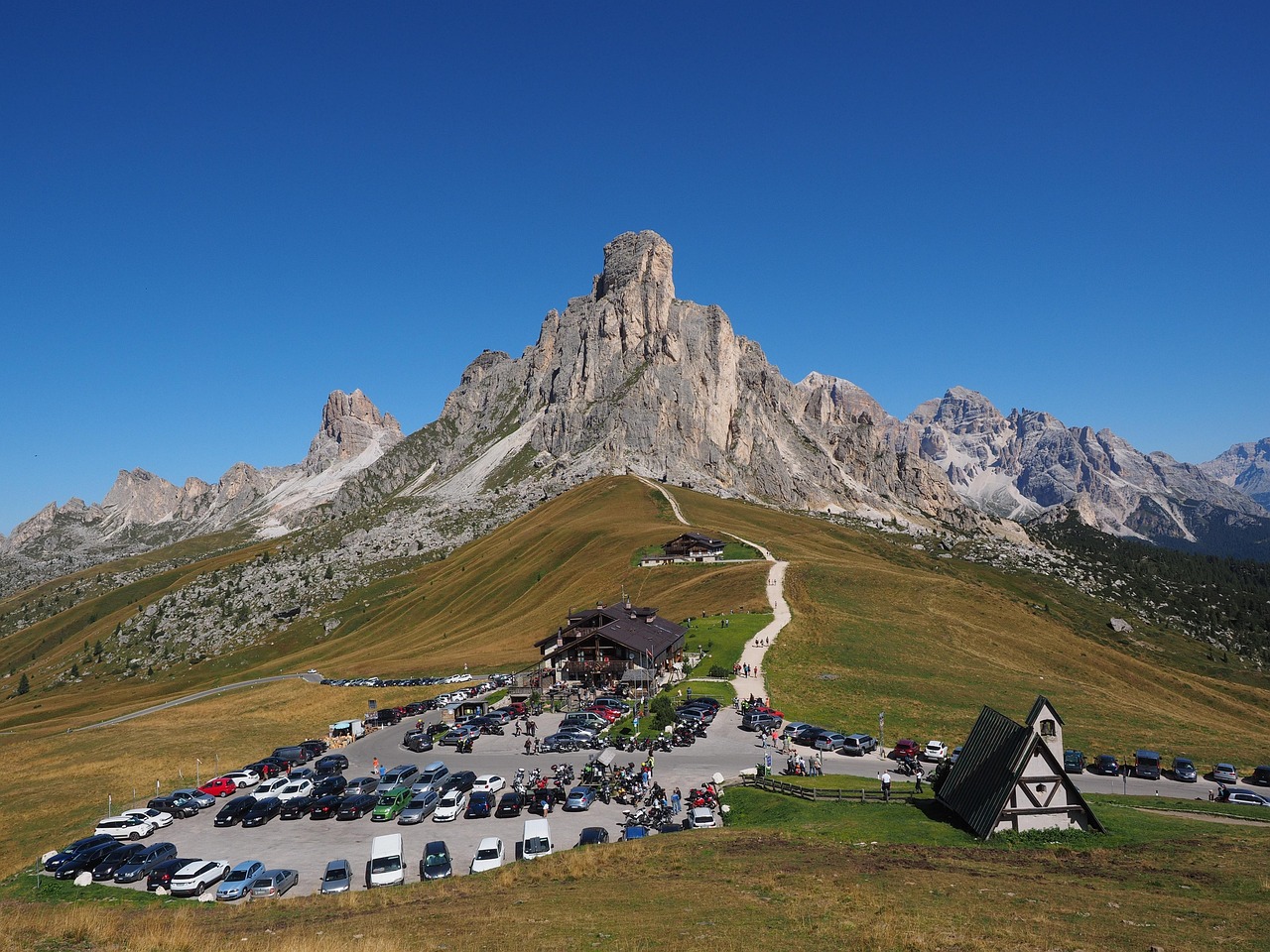 Mountain road and meadows at Passo Giau in Dolomites