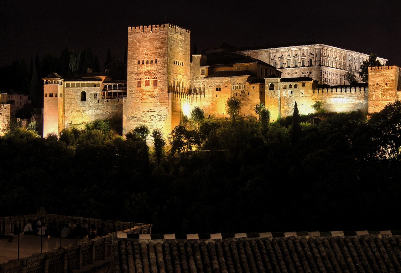Alhambra illuminated at night from across the valley
