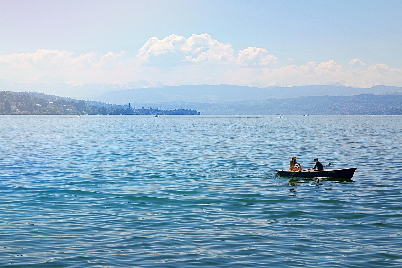 Boats on Lake Zurich with mountains in background